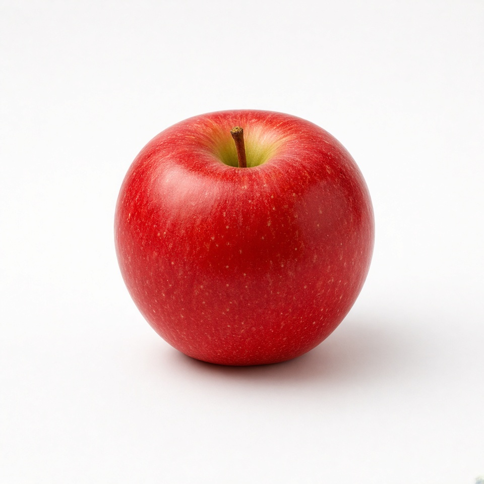 a single red apple on a white table, pro…