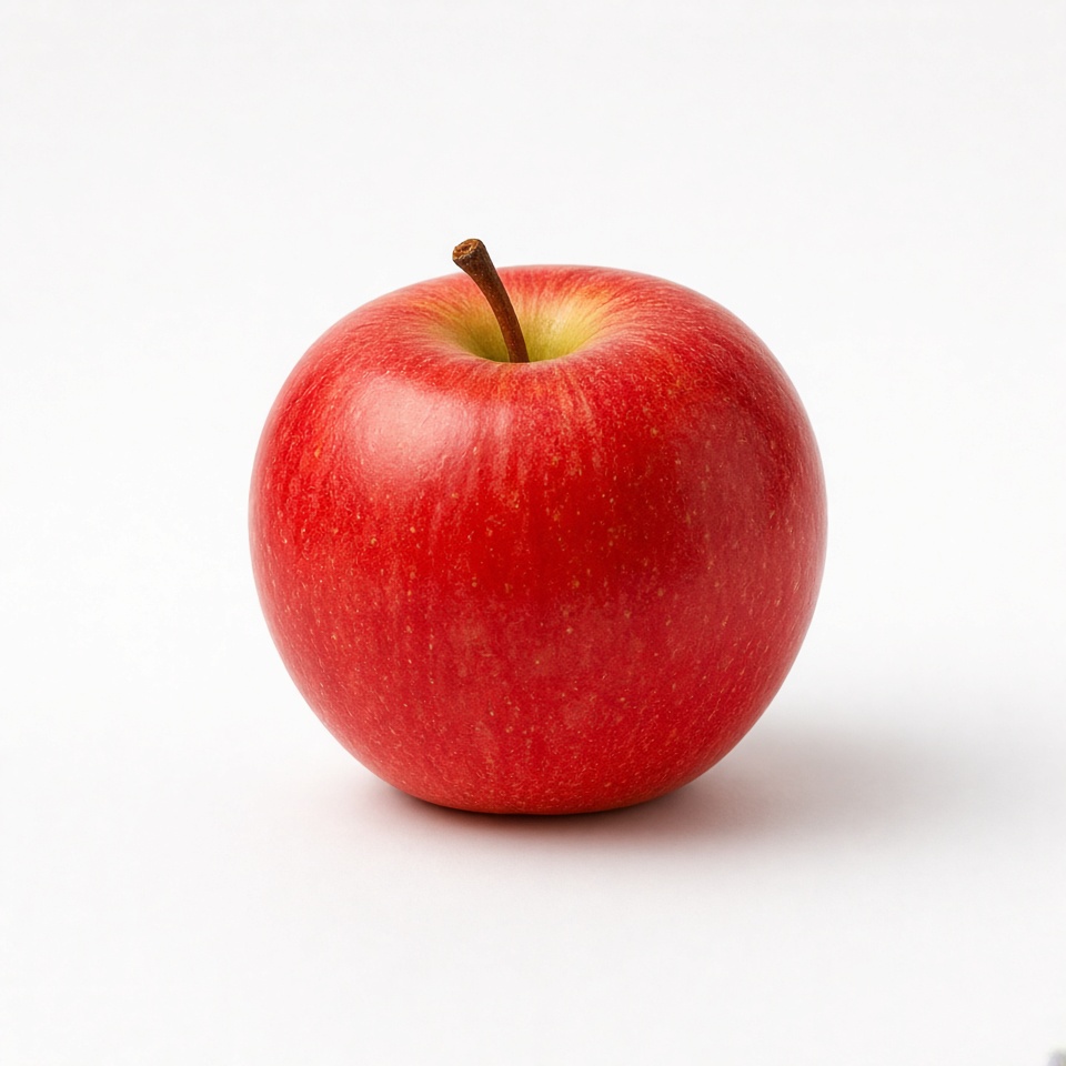 a single red apple on a white table, pro…